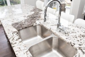 Quartz kitchen worktop featuring a double sink and modern faucet, showcasing a stylish and functional design for contemporary kitchens.