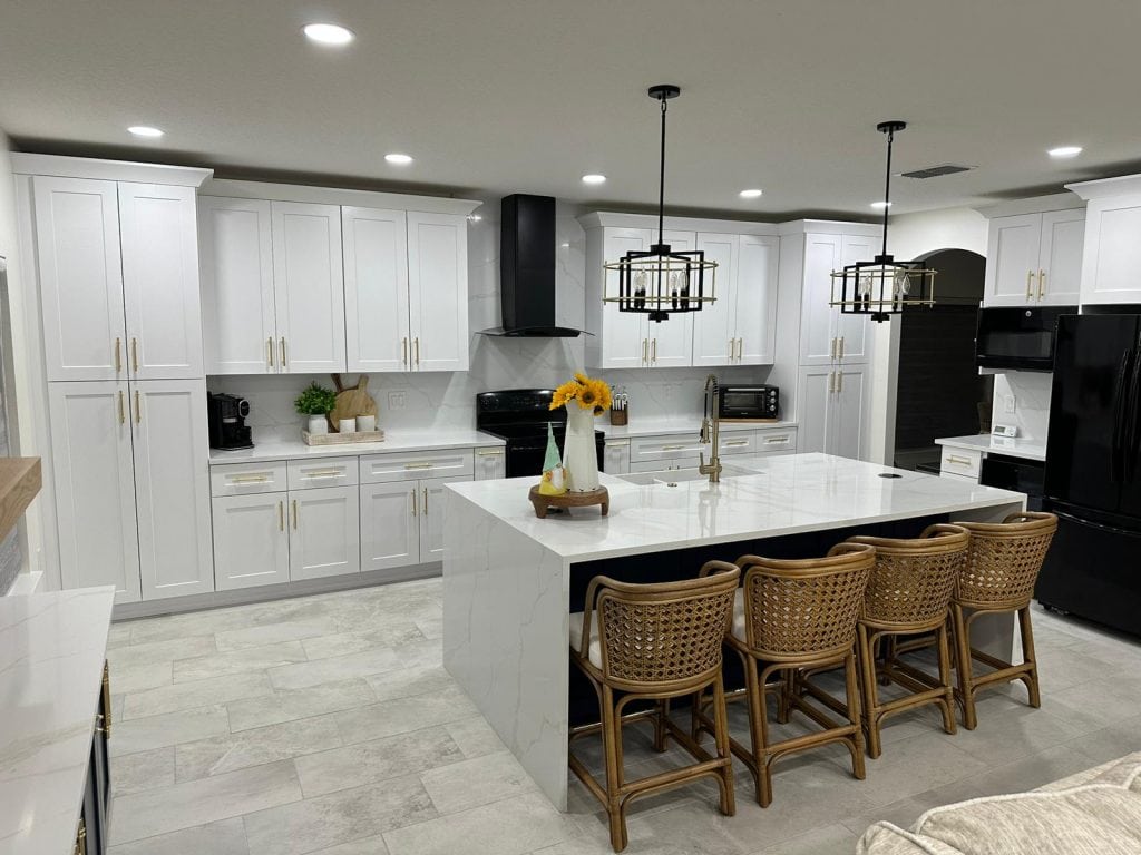 Calacatta Athena quartz countertops in a modern kitchen with white cabinetry and stylish bar seating, showcasing a sleek and elegant design.
